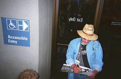 Eddie signs posters for Jacki, Gary and Jim and Cheryl